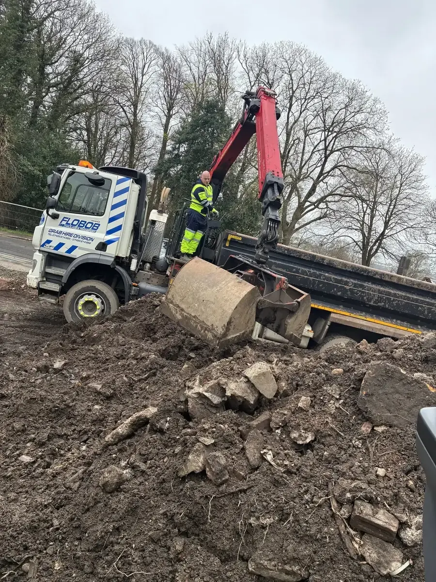 Grab Hire Scotland's red hydraulic crane collecting material
